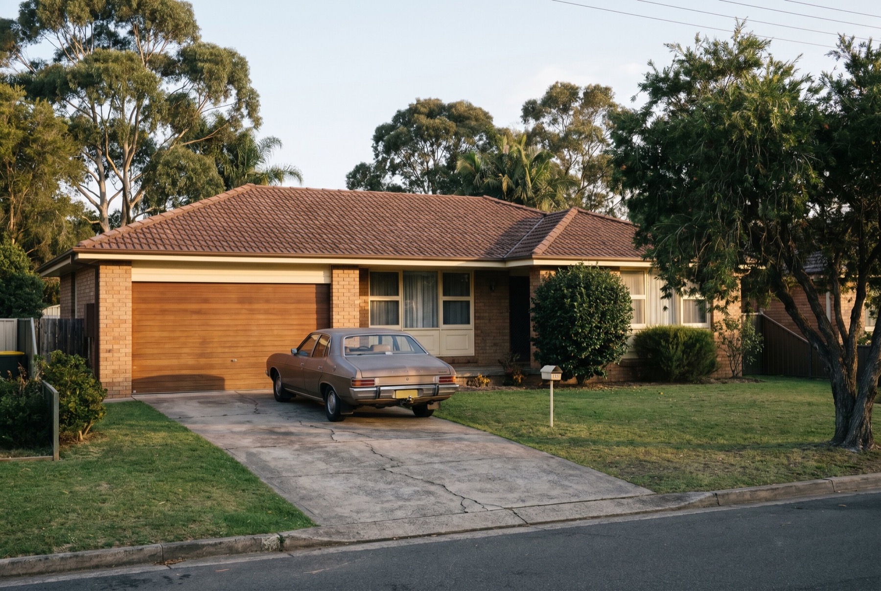 A 1970s brick veneer home with its original garage door