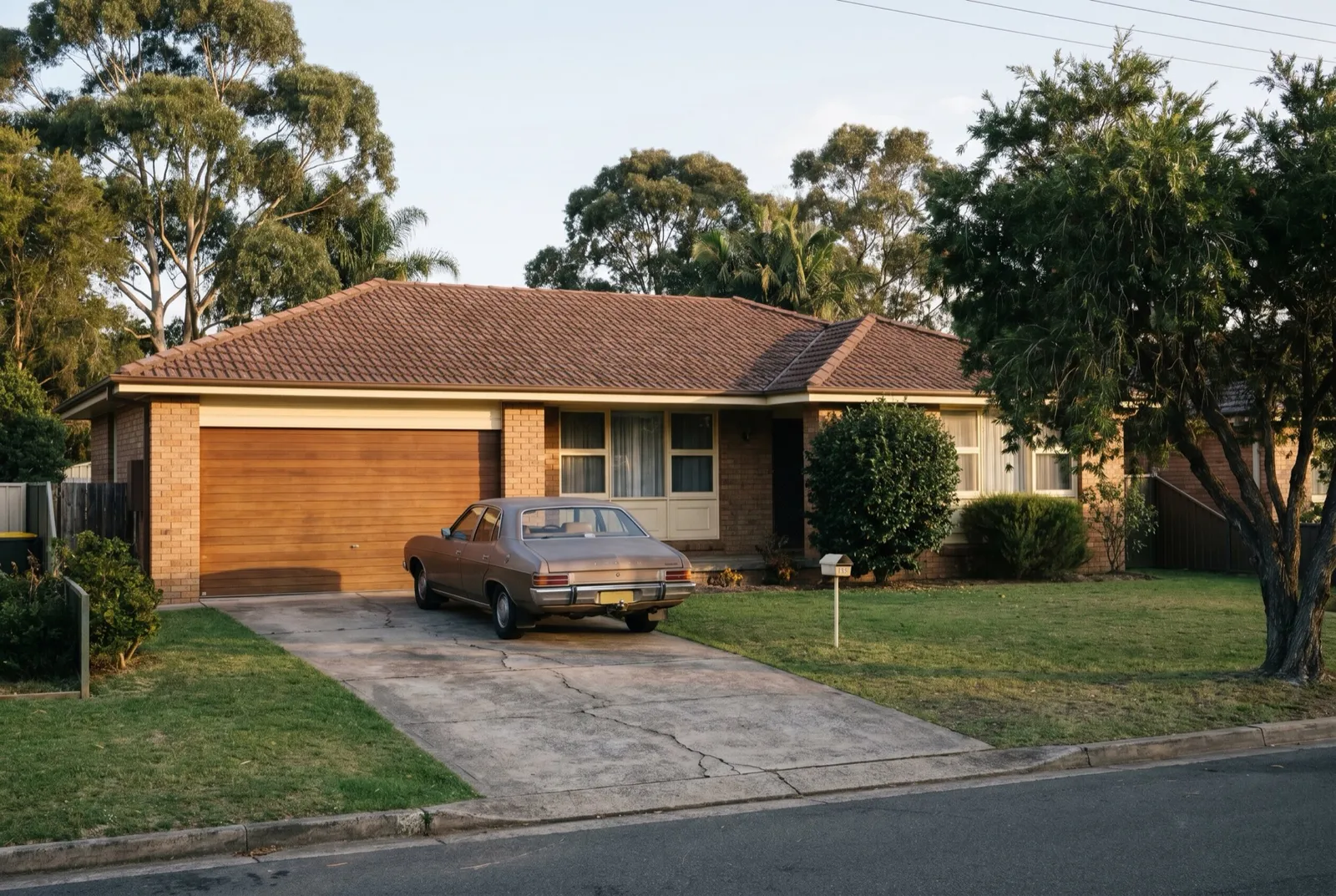 A 1970s brick veneer home with its original garage door